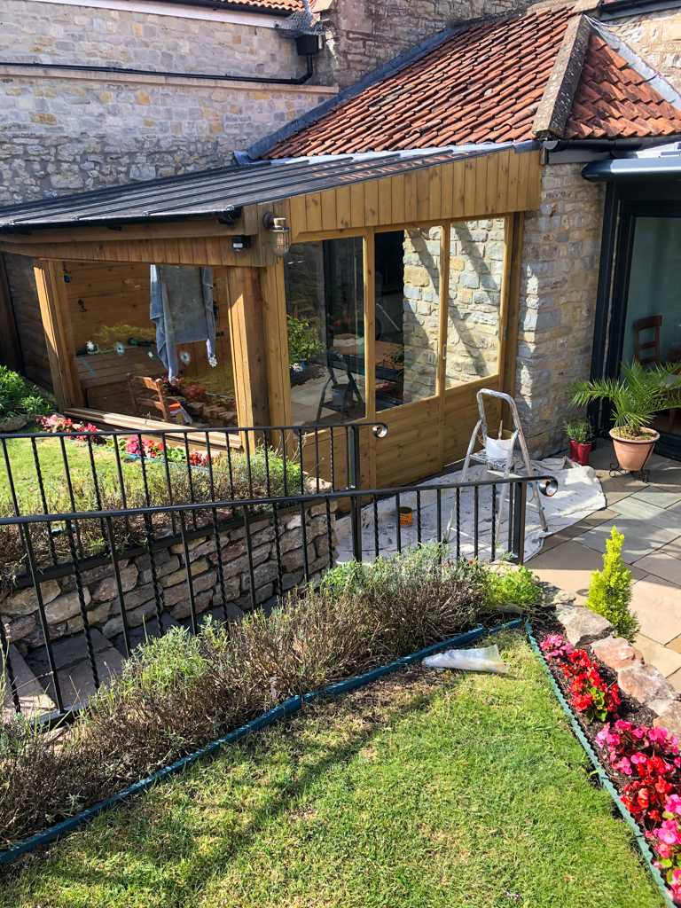 A bespoke extension with a pretty garden and a patio.